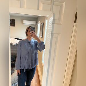 Simply Vera blue blouse with tie neck and ruffle detail.